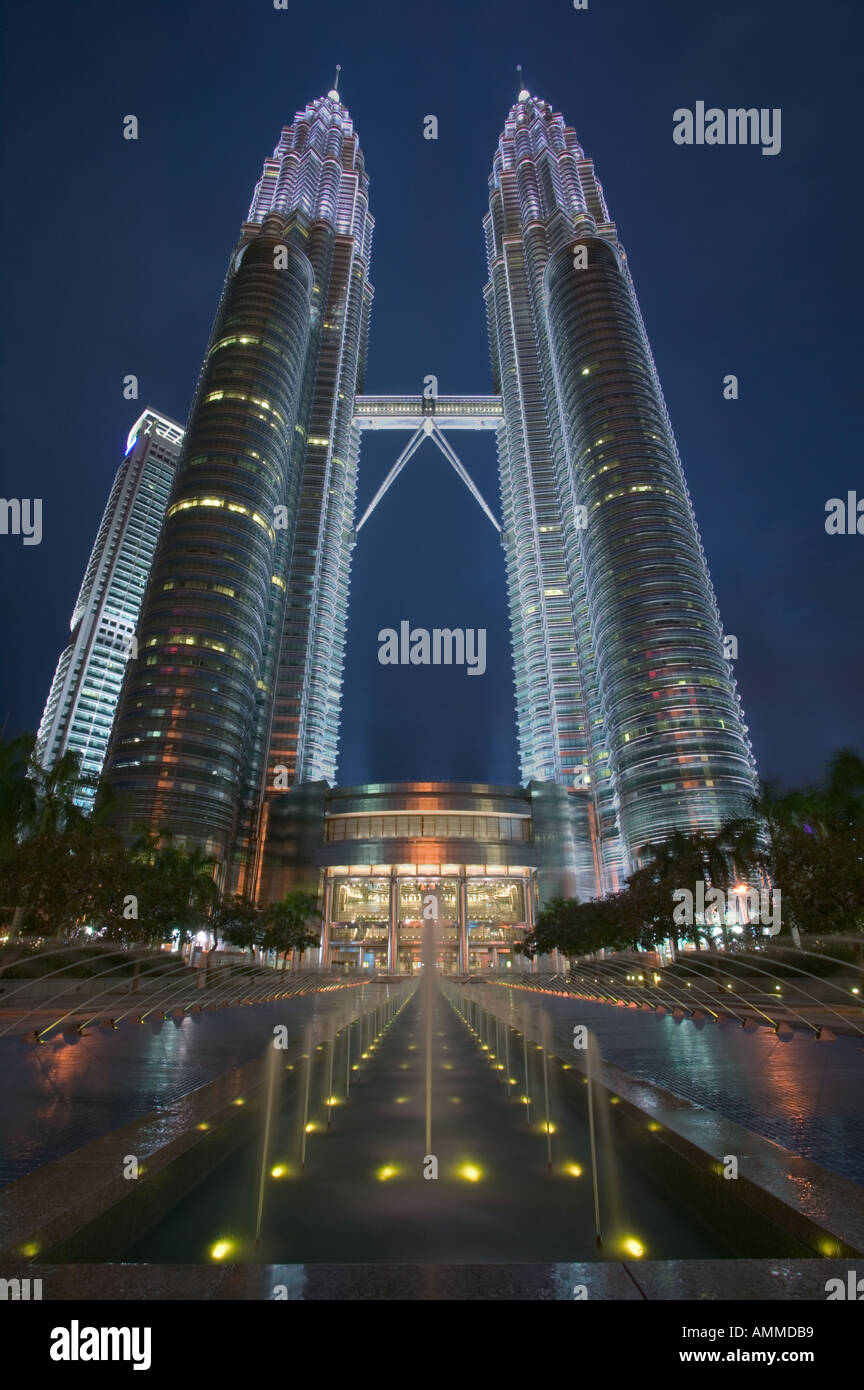 The Petronis Towers in Kuala Lumpur at dusk with an ornamental fountain in the foreground. Stock Photo