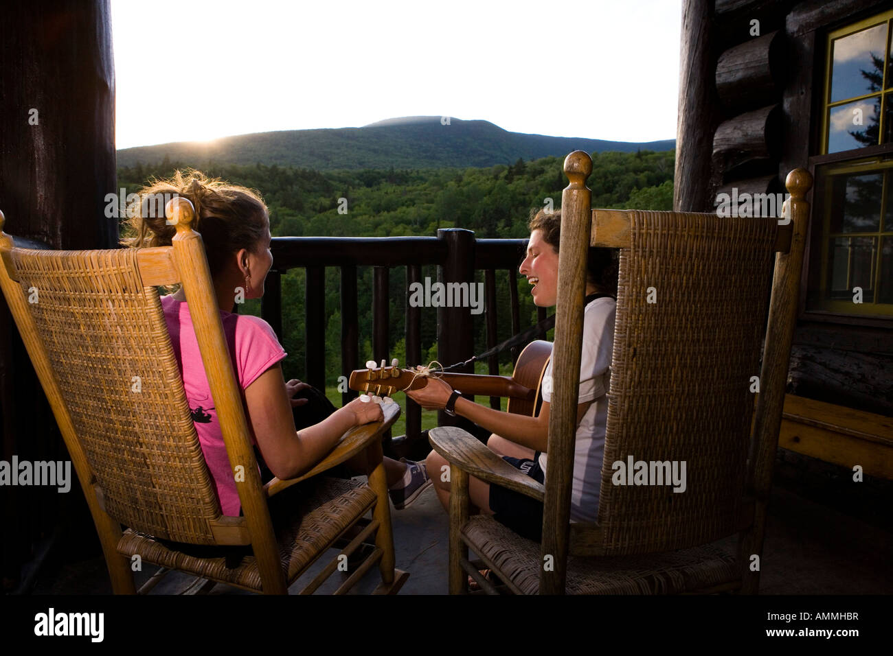 Two young women sing on the porch at the Moosilauke Ravine Lodge in New Hampshire USA Stock Photo