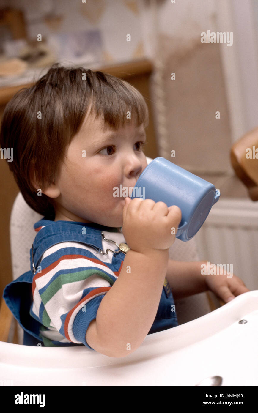 https://c8.alamy.com/comp/AMMJ4R/toddler-drinking-juice-from-a-non-spill-cup-at-mealtime-AMMJ4R.jpg