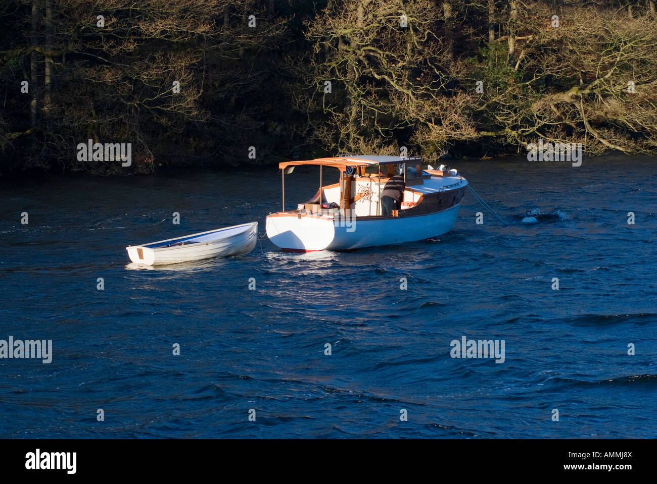 Old Motor Cruising Boat and Dinghy Moored on Lake Windermere Lake District National Park Cumbria England United Kingdom UK Stock Photo