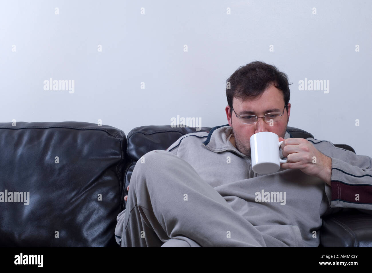 Man Sitting Down Drinking Coffee Tea Stock Photo Alamy