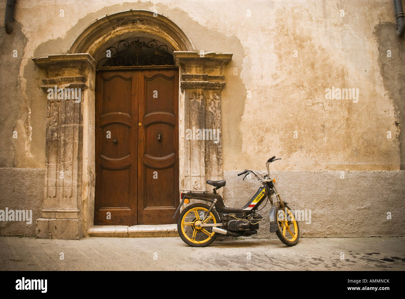 moped parked in front of old building, Sospel, Maritime Alps, France Stock Photo