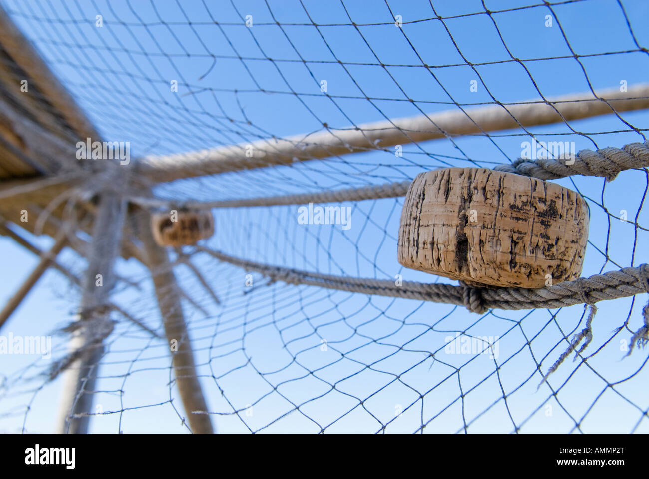 Old netting hanging from unused stockfish drying rack, Vestersand, Lofoten islands, Norway Stock Photo