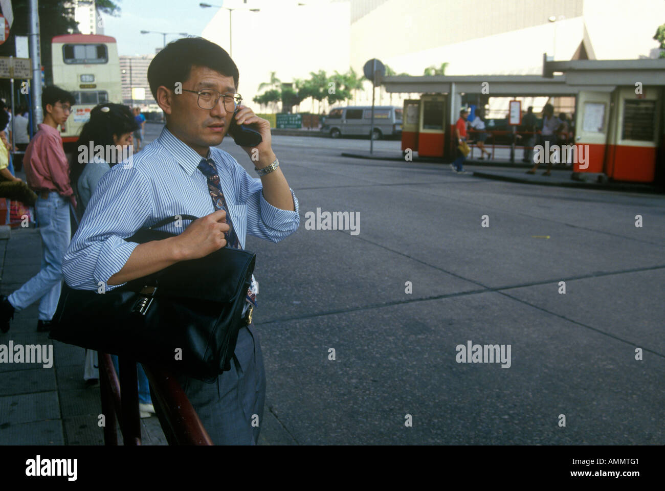 Businessman on cellular phone in Hong Kong Stock Photo