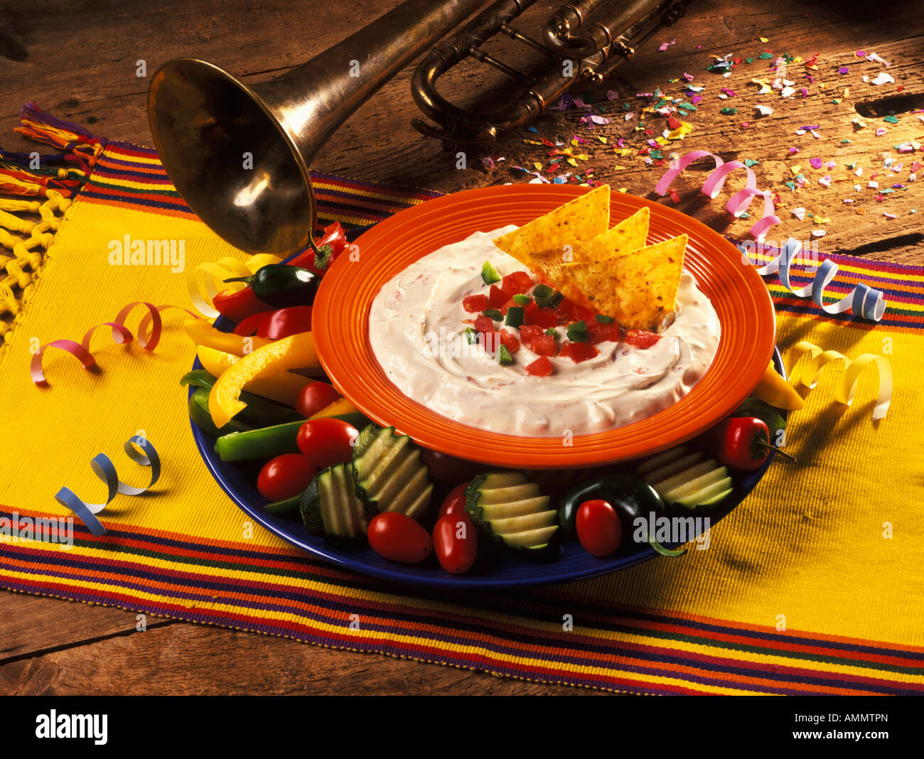 Party dip with tortilla chips and vegetables Stock Photo Alamy