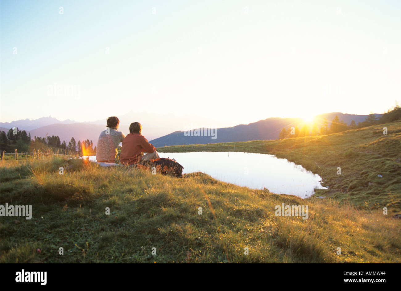 Two people watching sunset Stock Photo