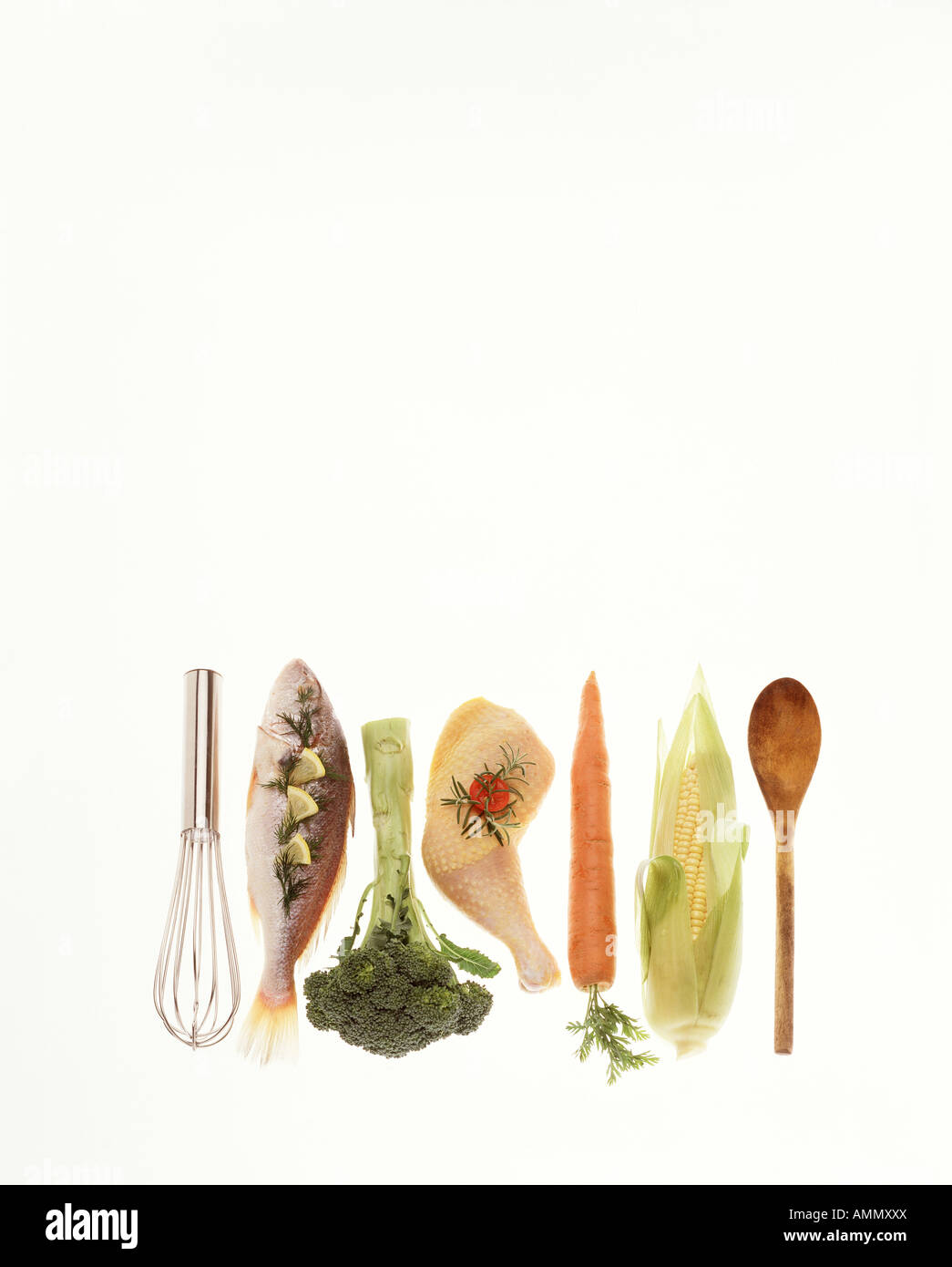 close up cook book recipe items raw fish chicken vegetable carrot corn on cob broccolli wooden spoon metal whisk copy space Stock Photo