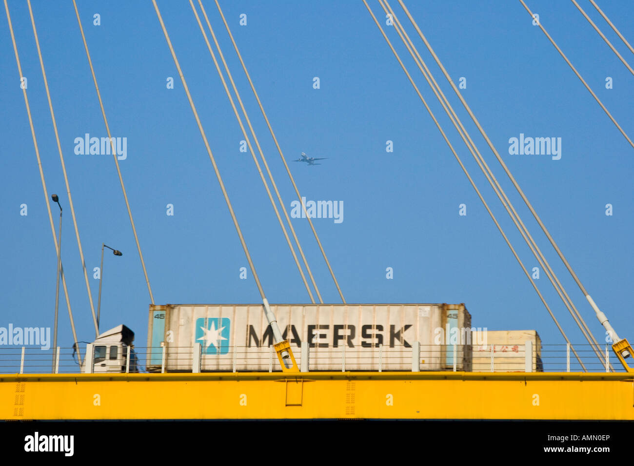 Freight Shipping Truck on its way to Mainland China Ting Kau Bridge Airplane overhead Hong Kong SAR Stock Photo