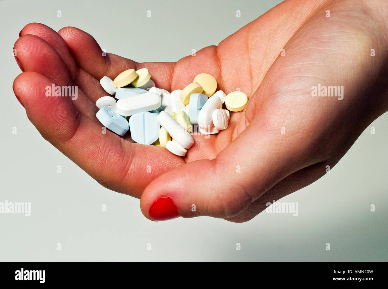 Hand holding pills (trademarks and logos in place) Stock Photo