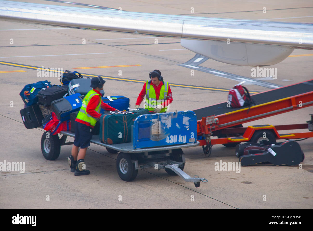 Baggage handlers loading an aircraft in Sydney Australia Stock Photo