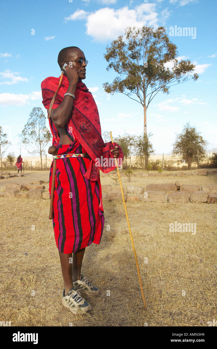 Masai Warrior using cell phone in village of Nairobi National Park Nairobi Kenya Africa Stock Photo