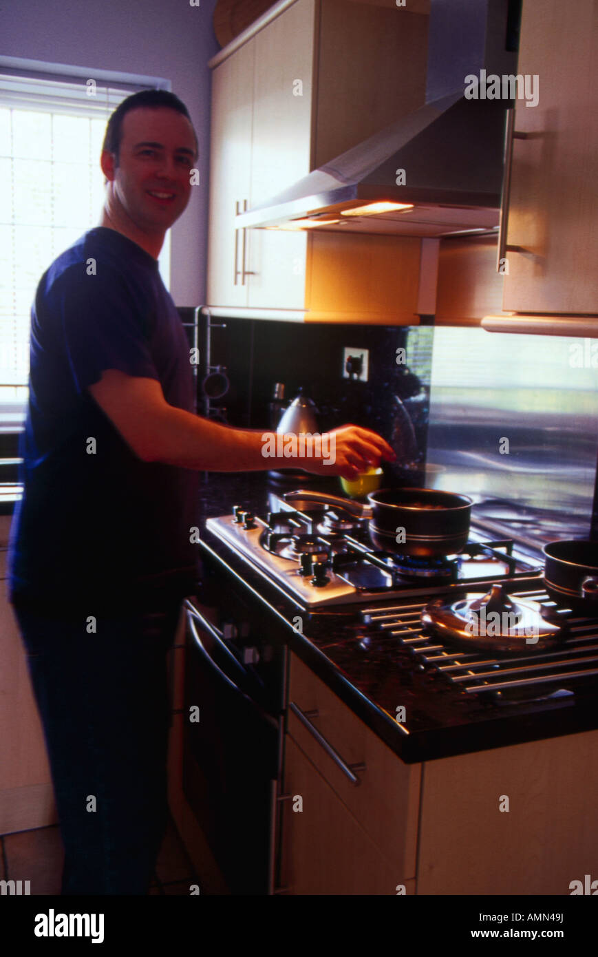 Man cooking on gas stove Stock Photo - Alamy