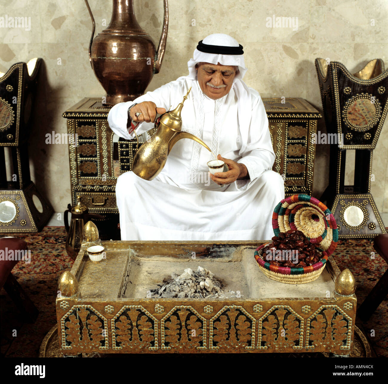 Arabic man pouring coffee, Bahrain Stock Photo Alamy