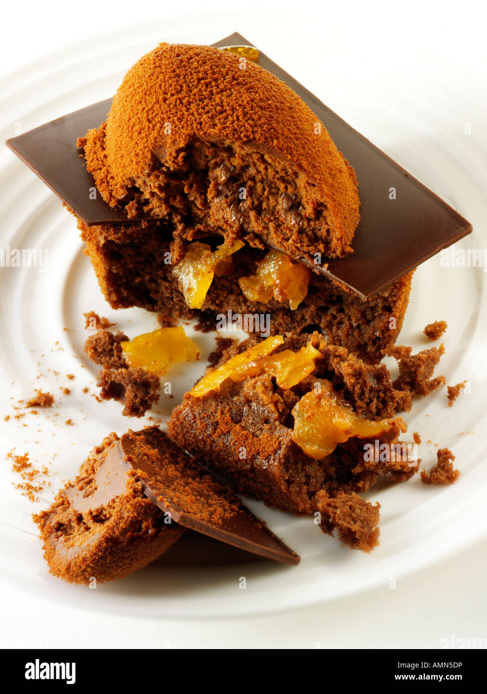 A hand made patisserie speciality rich indulgent chocolate cake filled with with coffee in a white table setting Stock Photo