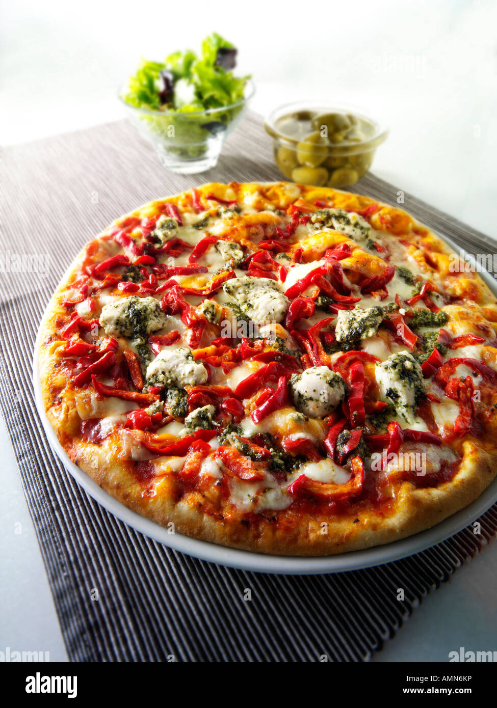 Whole chicken and pepper topped pizza Stock Photo