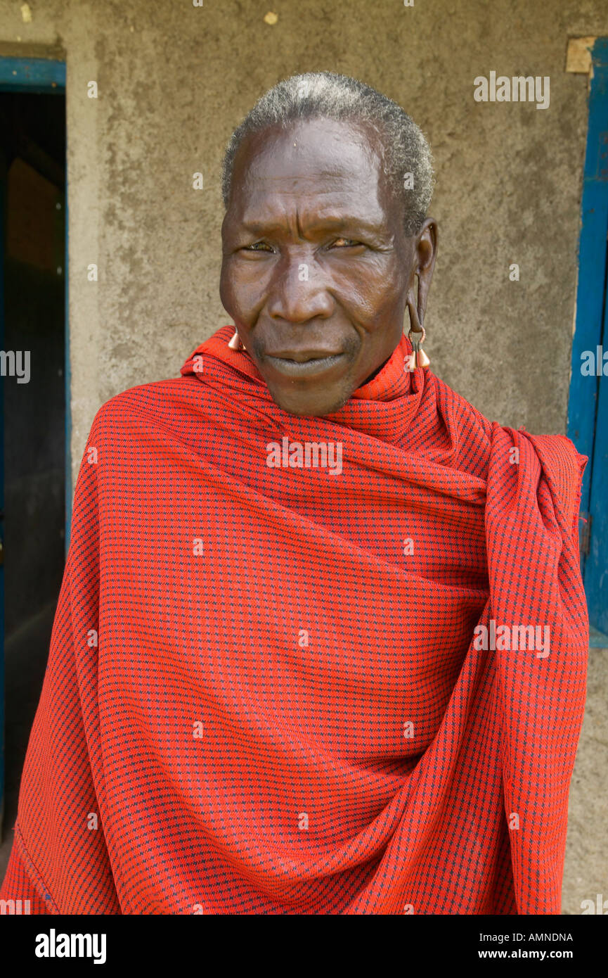 Masai Senior Elder man in red robe in village near Tsavo National Park Kenya Africa Stock Photo