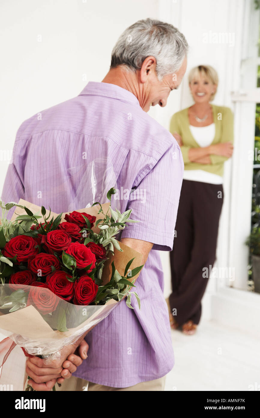 Man Giving Flowers To Woman High Resolution Stock Photography and