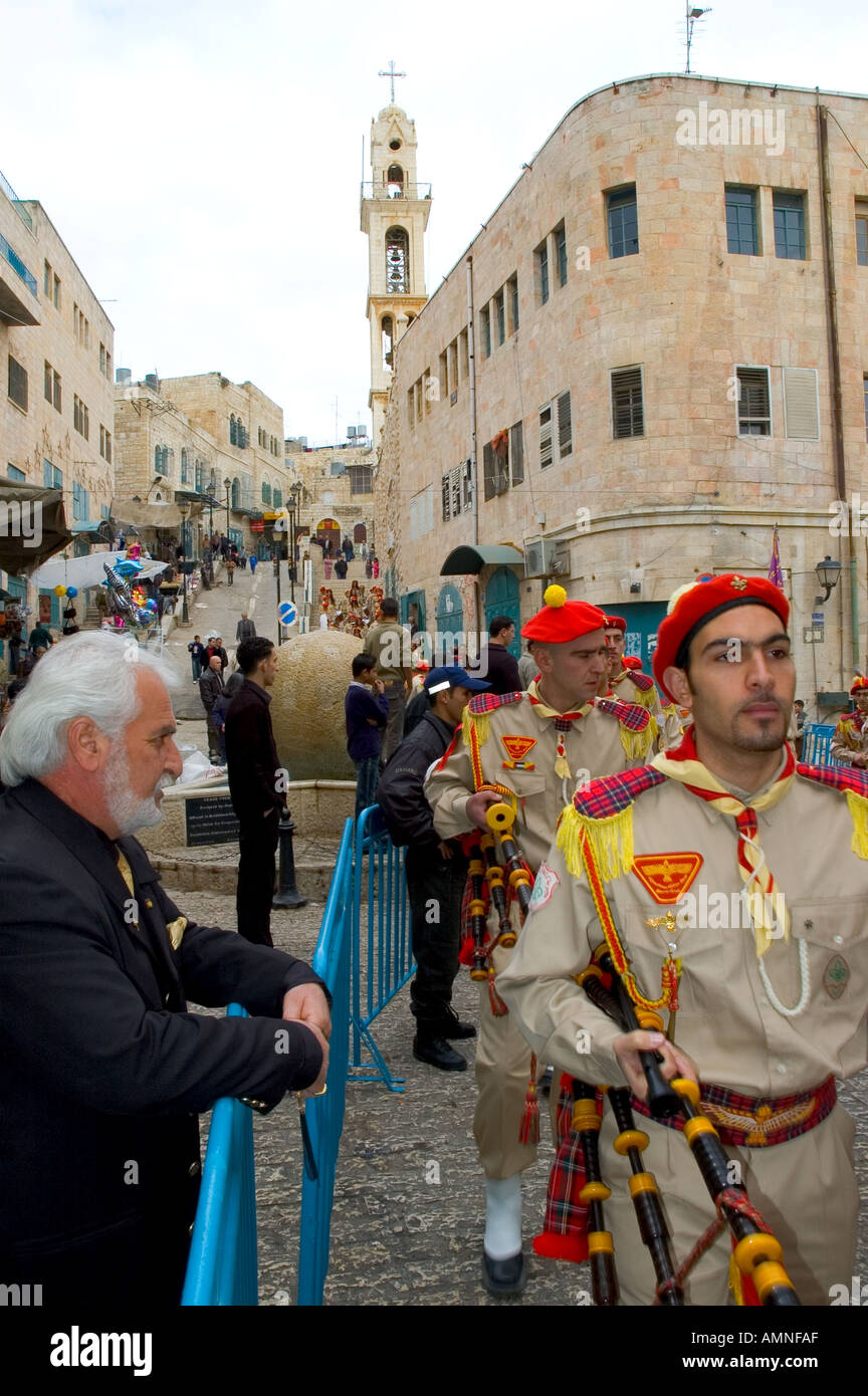 Palestinian Authority Bethlehem Manger Square scouts band marching through the streets with elegant christian man watching Stock Photo