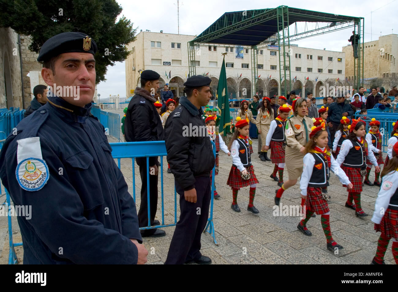 Palestinian Authority Bethlehem Manger Square young scout girls in uniform marching with palestinian policemen watching Stock Photo