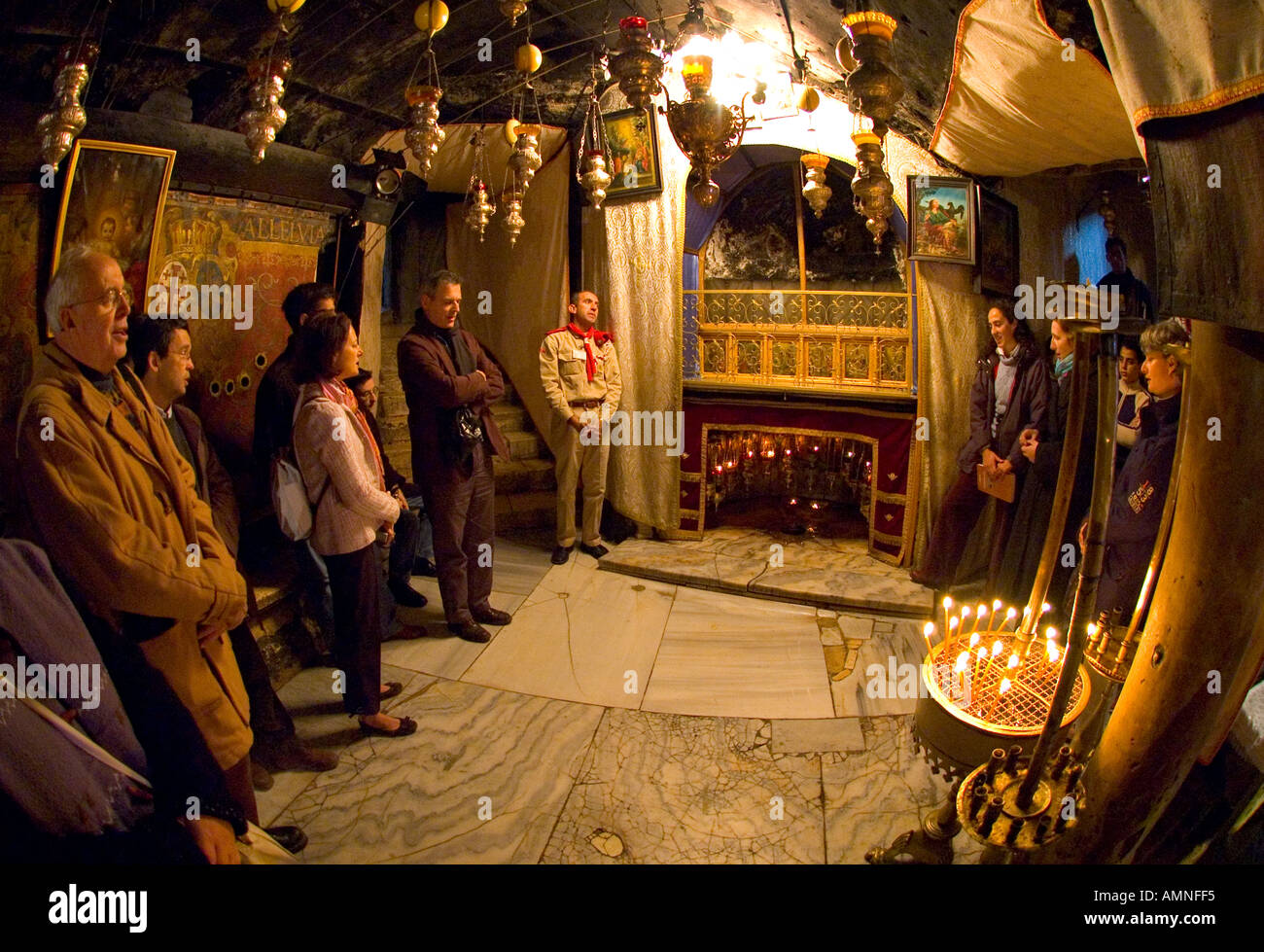 Palestinian Authority Bethlehem church of the Nativity grotto of Ste catherine groupe of pilgrims singing in front of the star at the spot where Jesus was born Stock Photo