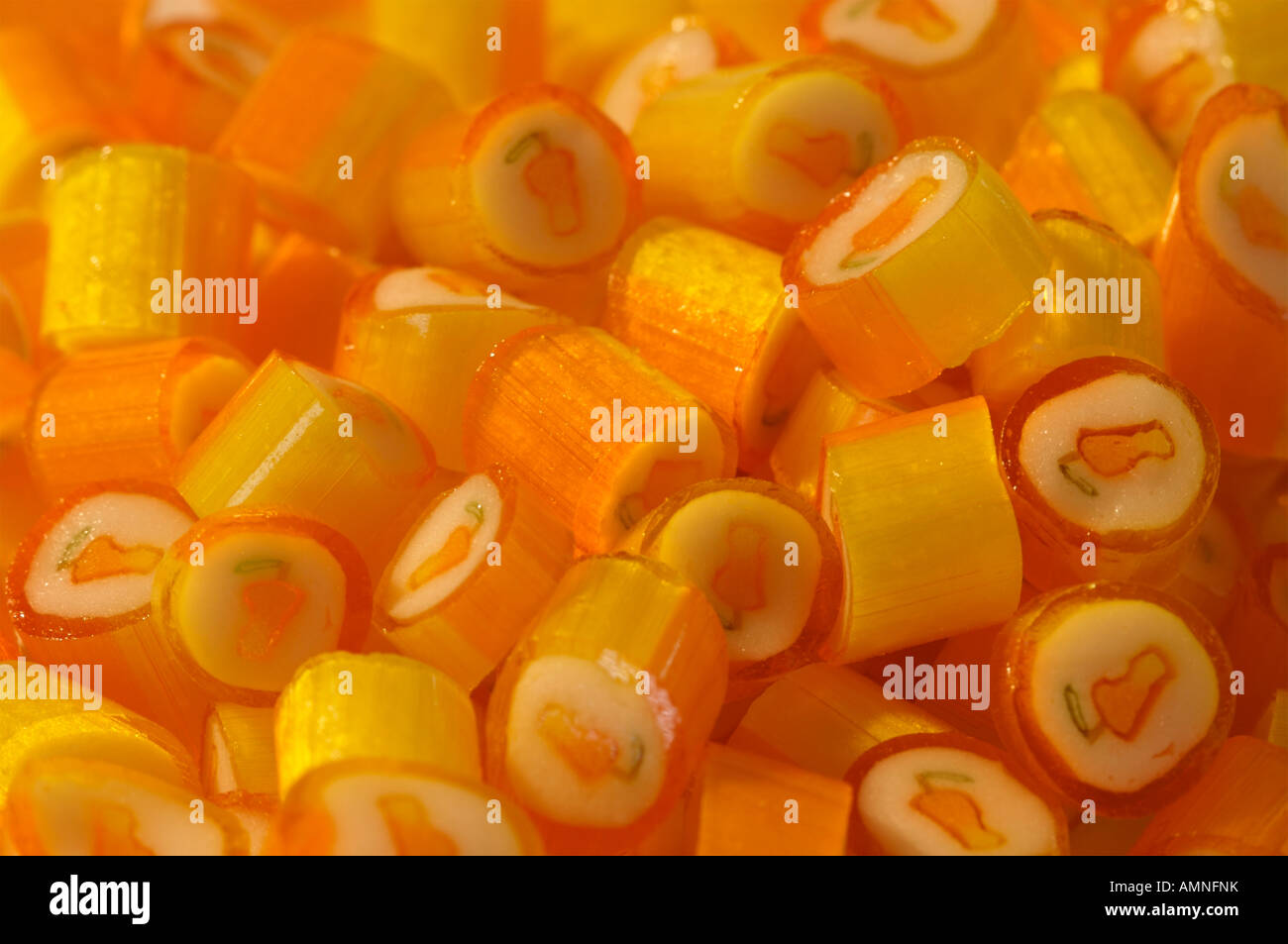 Orange and white candy with mango image on them Stock Photo Alamy
