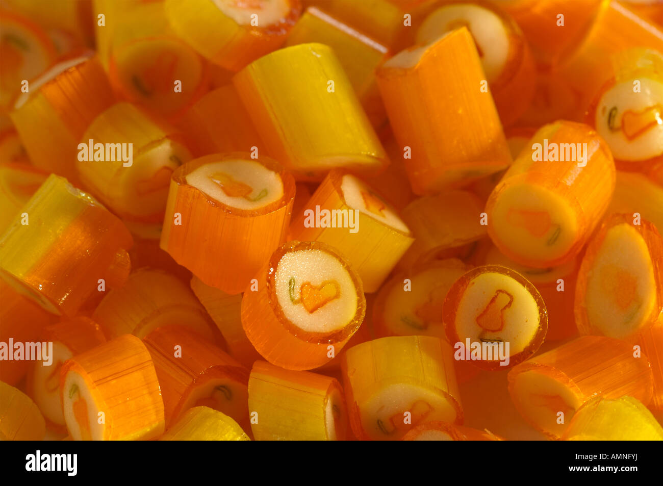 Orange and white candy with mango image on them Stock Photo Alamy