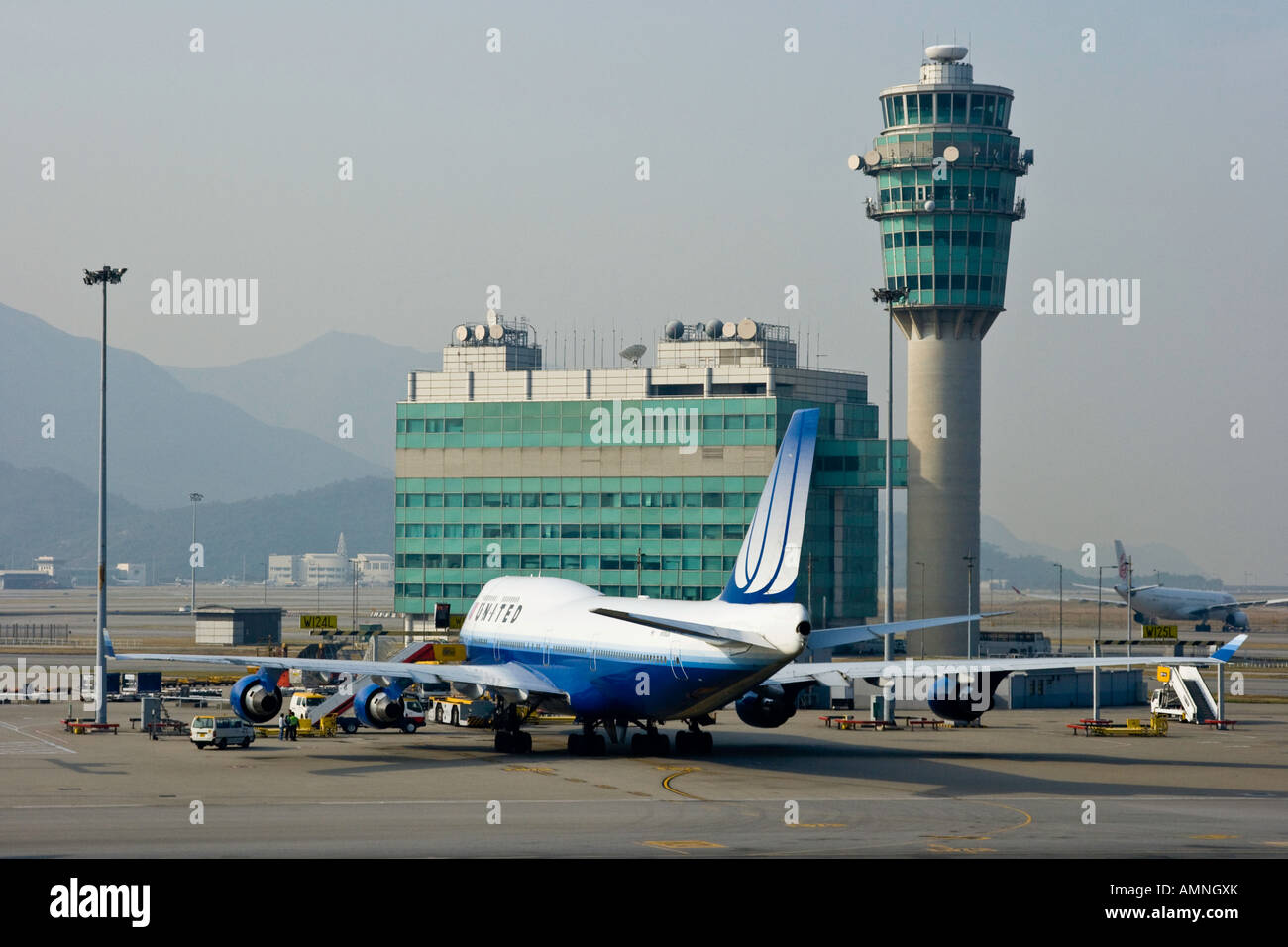 United Airline Commercial Airplane and Conning Tower at HKG Hong Kong International Airport Stock Photo