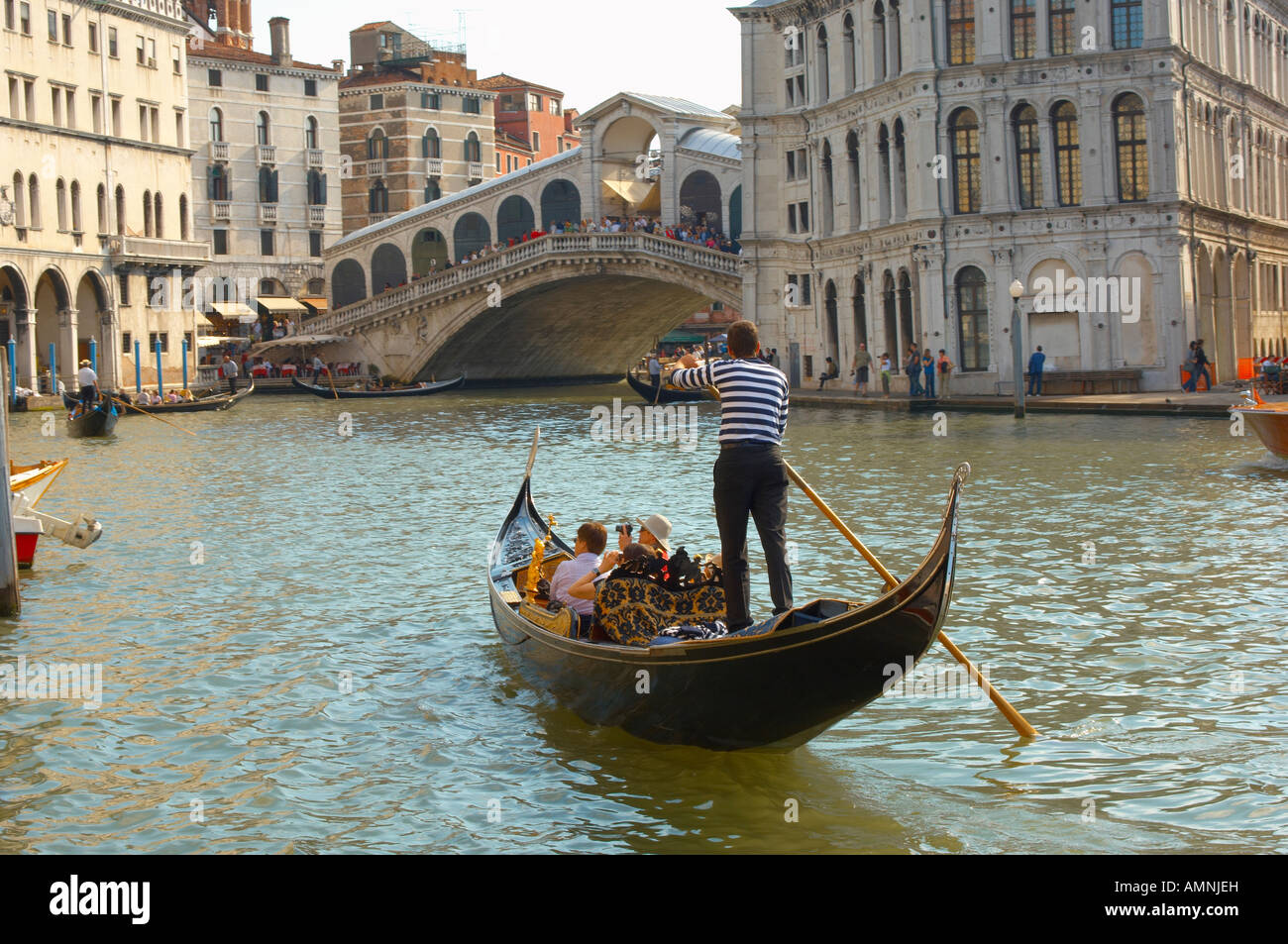 Tourist in a gondola on the Grand Canal having a romantic day trip, Venice Italy Stock Photo