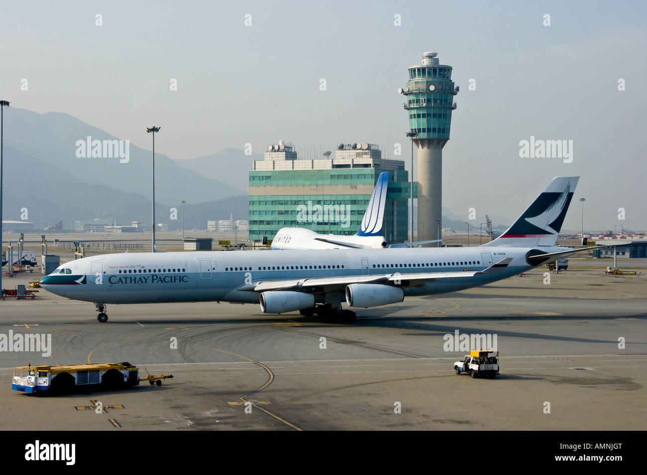 Cathay Pacific Airline Commercial Airplane and Conning Tower at HKG Hong Kong International Airport Stock Photo