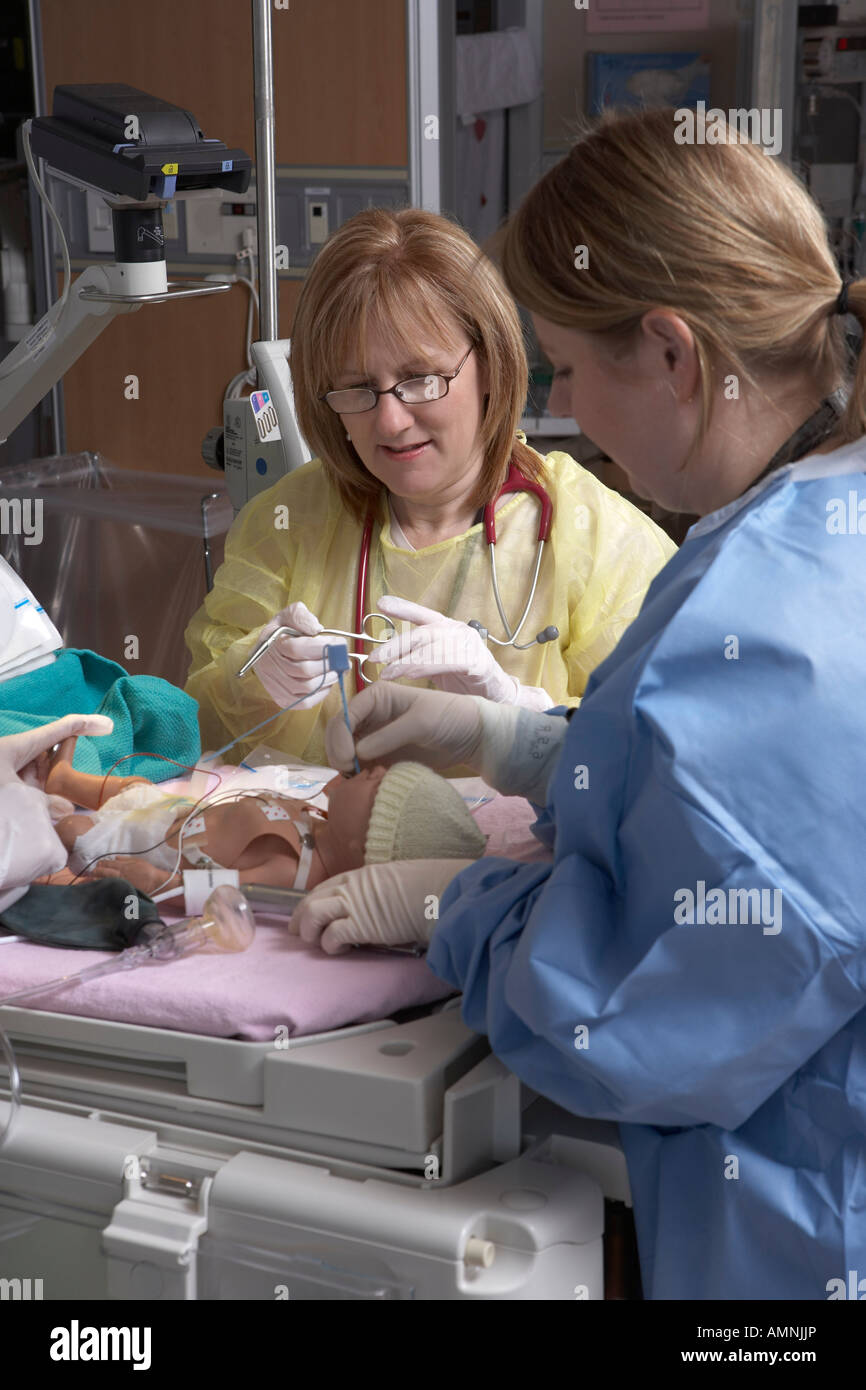 Nurses Practicing with Baby Mannequin Stock Photo - Alamy