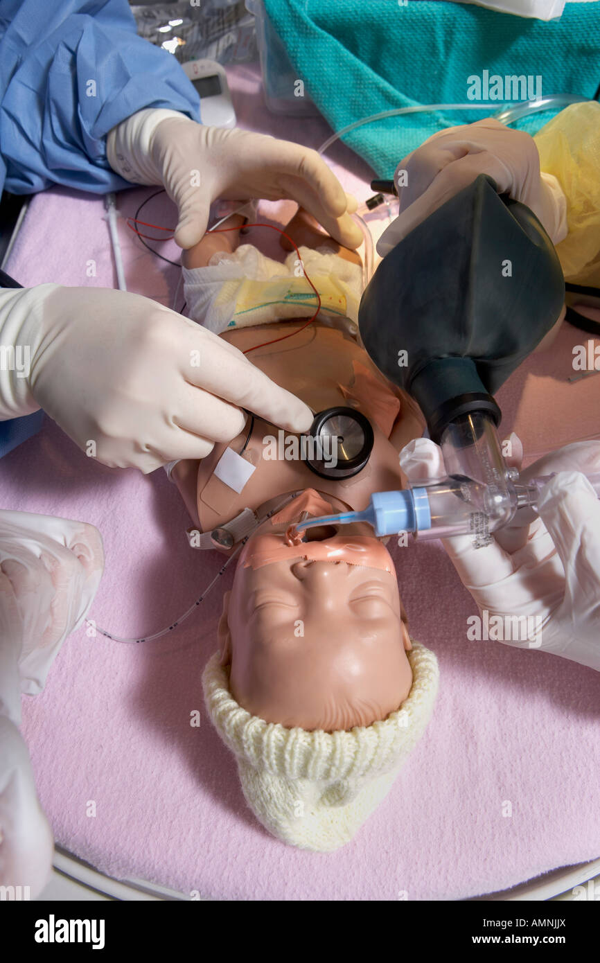 Nurses Practicing on Baby Mannequin Stock Photo