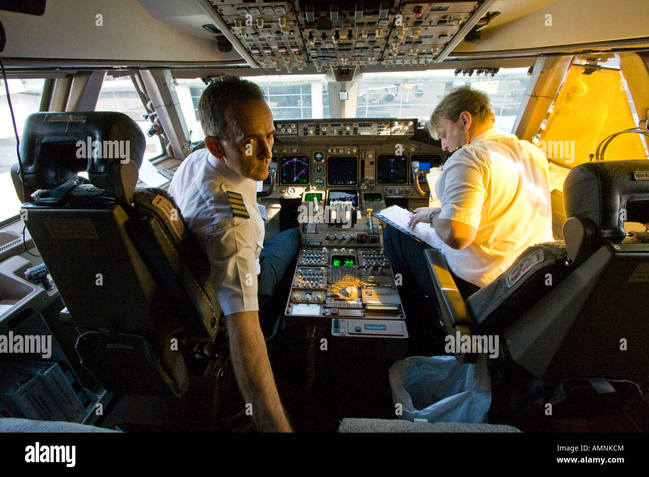 Captain and Crew in the Cockpit of a Cathay Airway 747 Boeing Commercial Jet Airplane Stock Photo