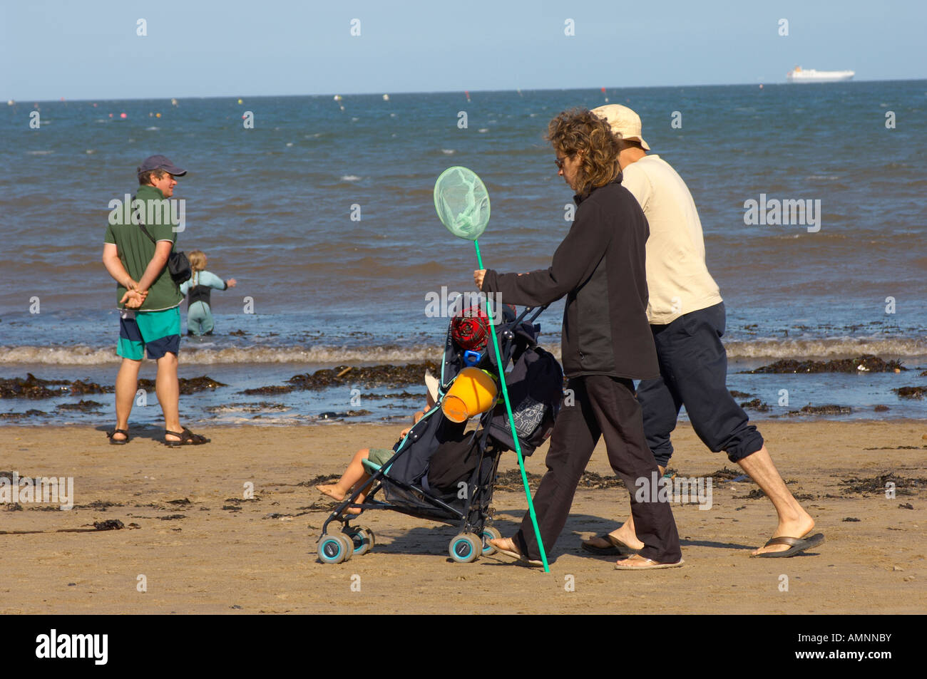 Family walking along the beach. Runswick Bay North Yorkshire England Stock Photo