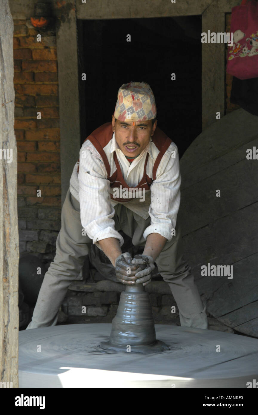 Potter working on the turntable at Potters Square Bhaktapur Nepal Stock Photo