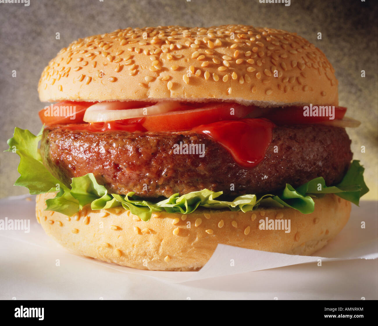 Classic beef  burger in bun with Ketchup Salad in a sesame bun. Quarter or half pounder. Stock Photo