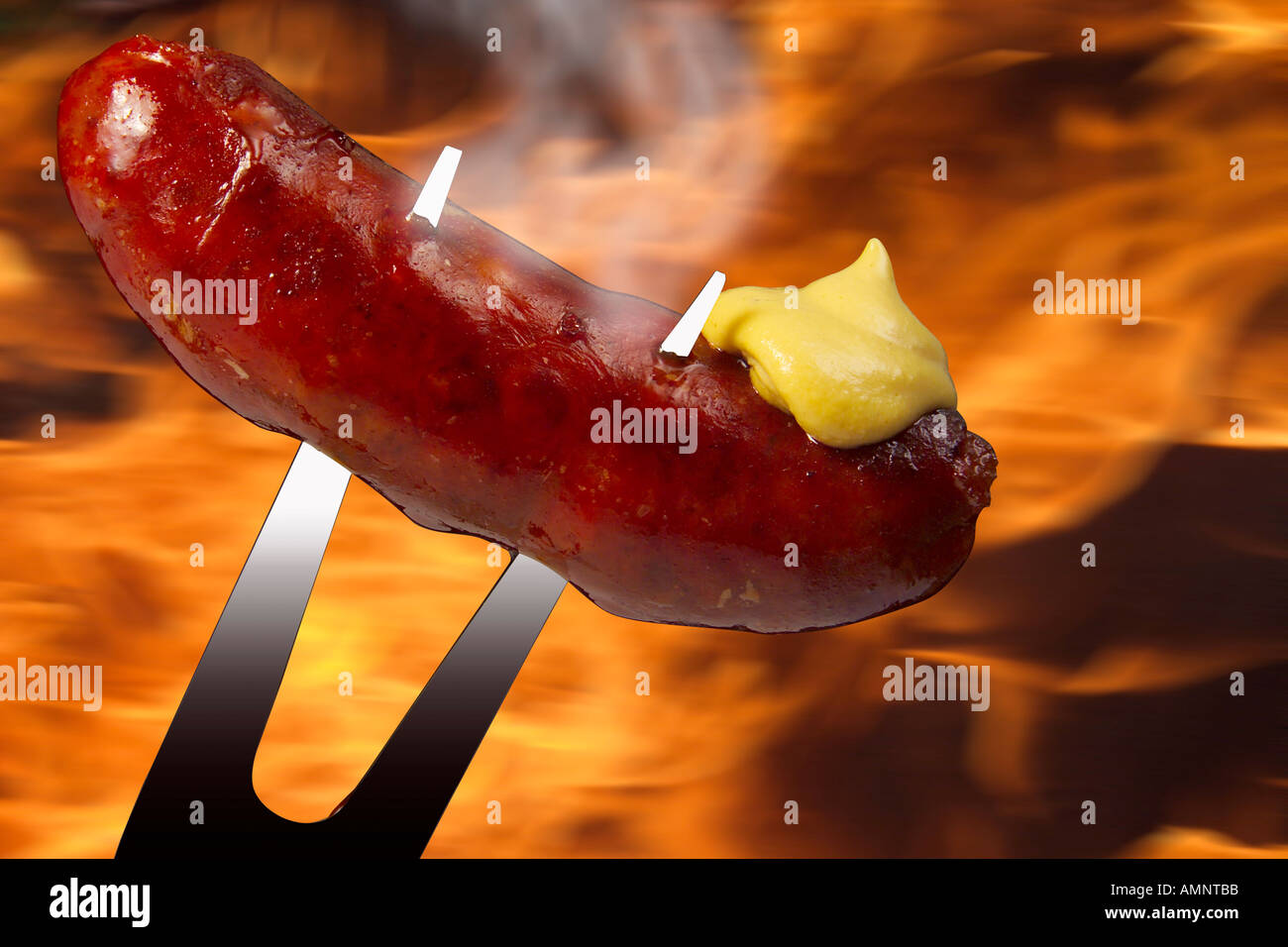 Roast sausage with mustard on fork Stock Photo
