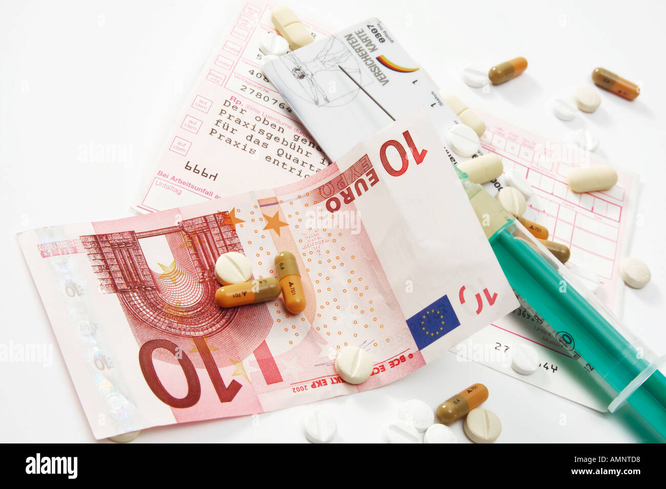 Ten euro note and pills on letter of referral Stock Photo