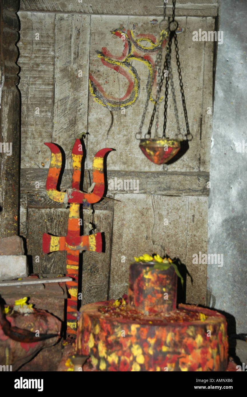 Shrine for god Shiva with a lingam and trisul red yellow and orange coloured Kathmandu Nepal Stock Photo
