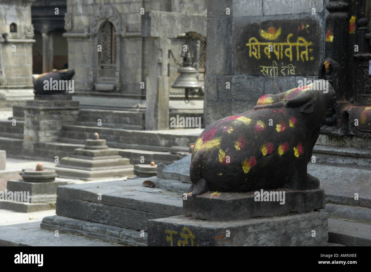 Figure of bull Nandi with red and yellow spots in front of Shiva shrines Pashupatinath Kathmandu Nepal Stock Photo