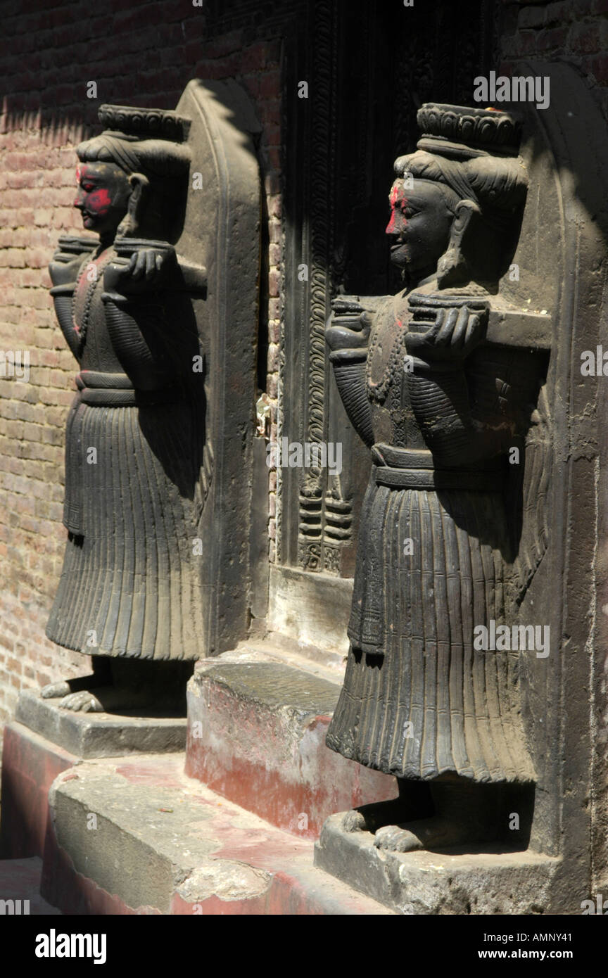 Two figures with red coloured cheeks Royal Palace Bhaktapur Nepal Stock Photo