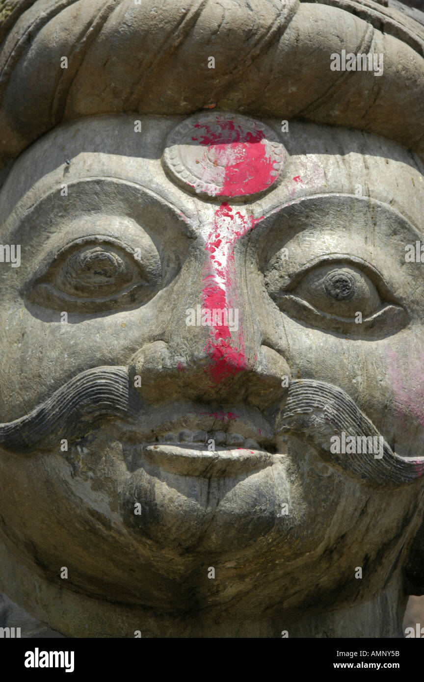 Face carved in stone with red colour Durbar Square Bhaktapur Nepal Stock Photo