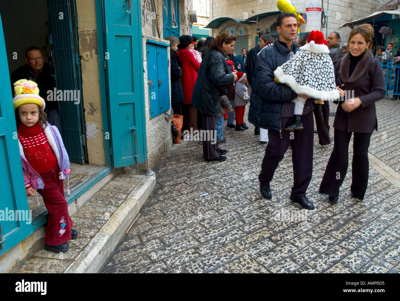 Palestinian Authority Bethlehem near Manger Square christian palestinian couple with child in the street waiting for the arrival of the latin patriarch Stock Photo