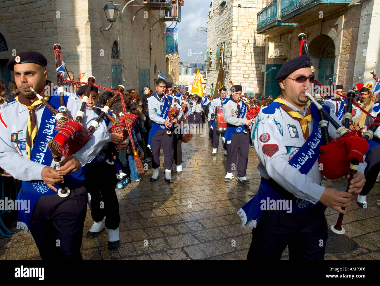 Palestinian Authority Bethlehem near Manger Square scouts pipe band marching through bethelehem streets with people watching Stock Photo