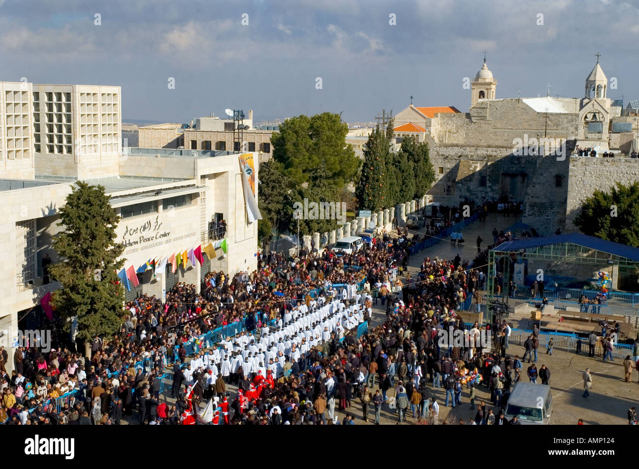 Palestinian Authority Bethlehem Manger Square and church of the Nativity elevated view with crowd and priests procession waiting for arrival of latin patriarch on christmas day Stock Photo