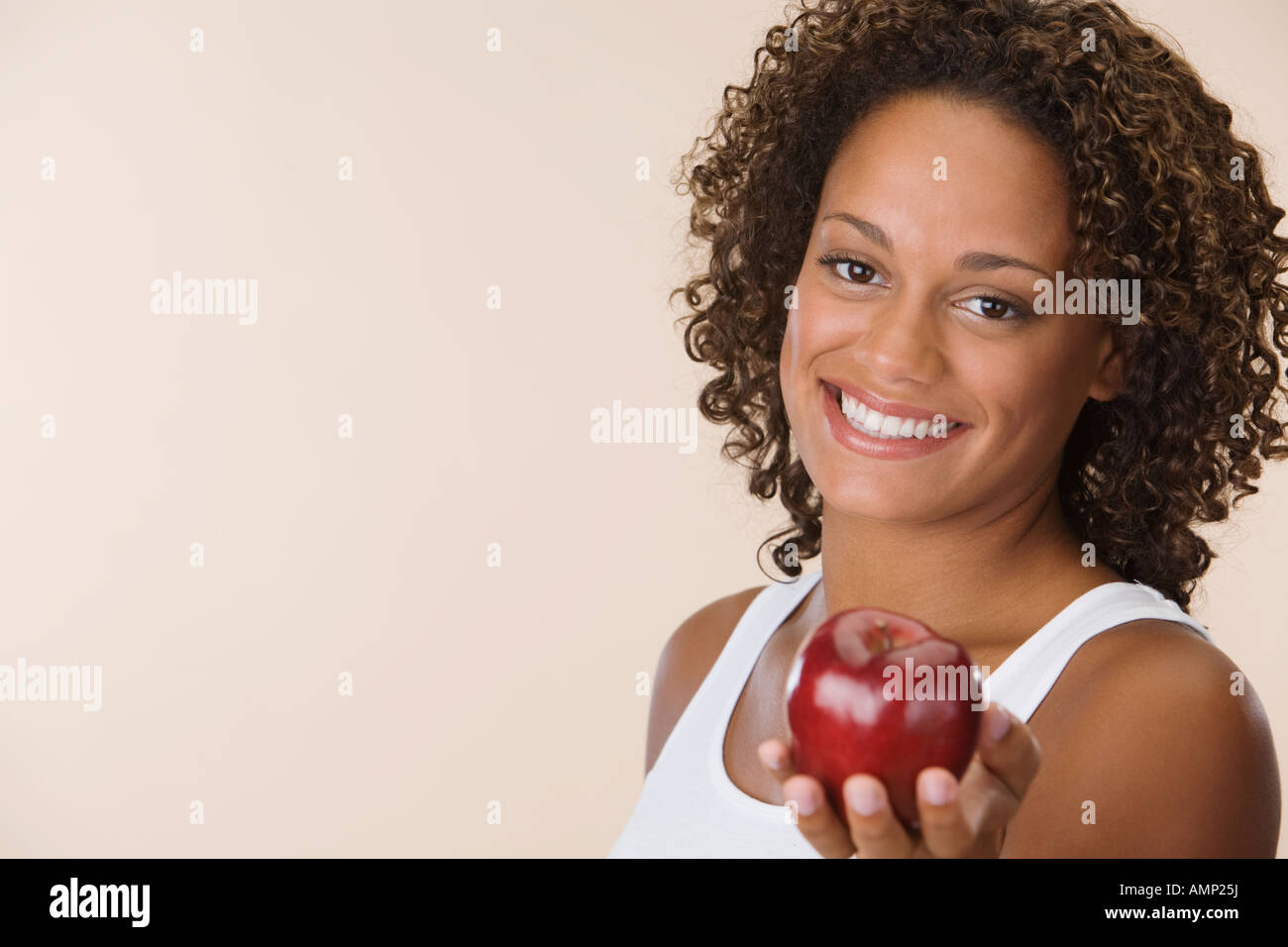 African woman holding apple Stock Photo