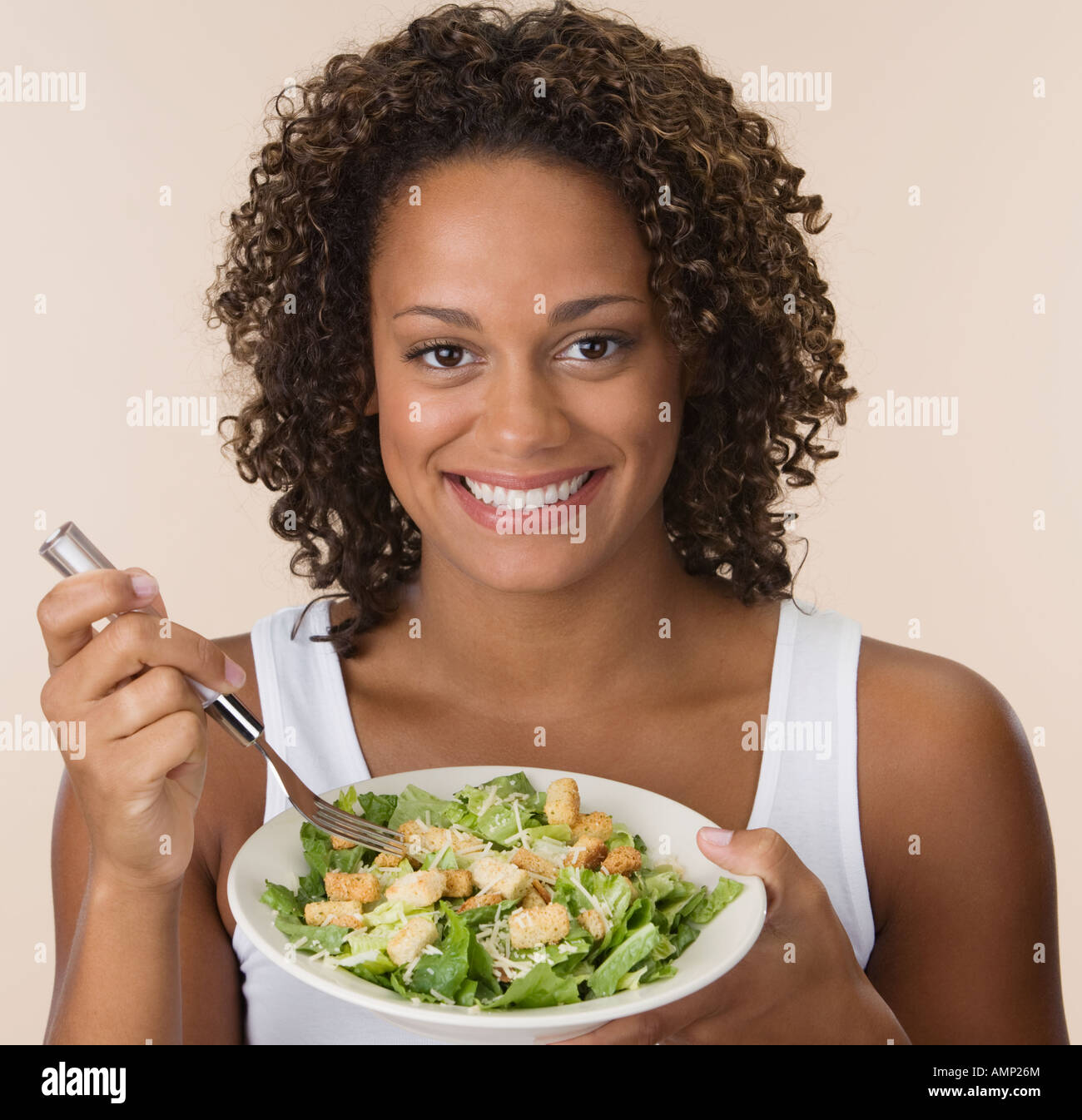 African woman eating salad Stock Photo