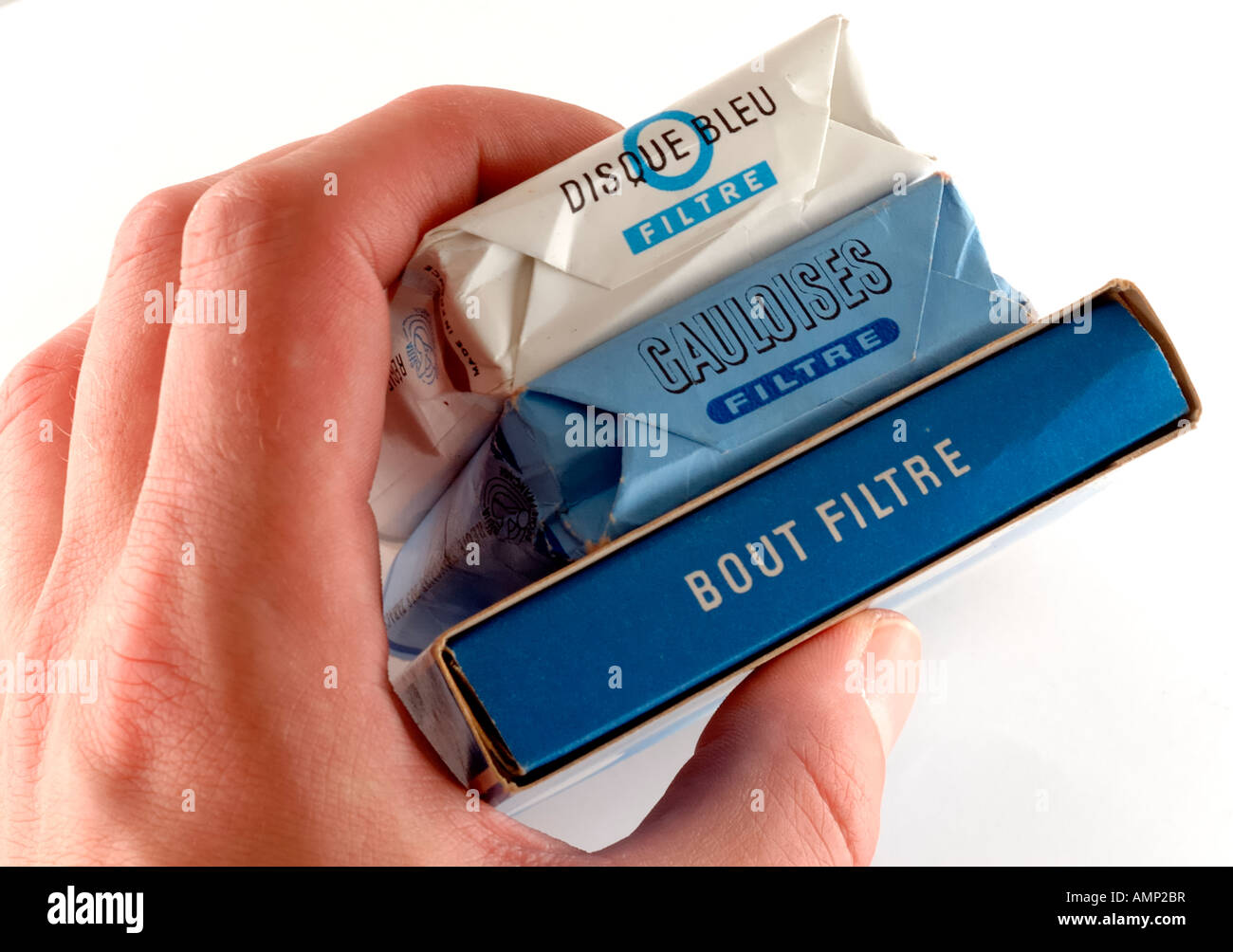 Hand Holding Packets of French Cigarettes. Stock Photo