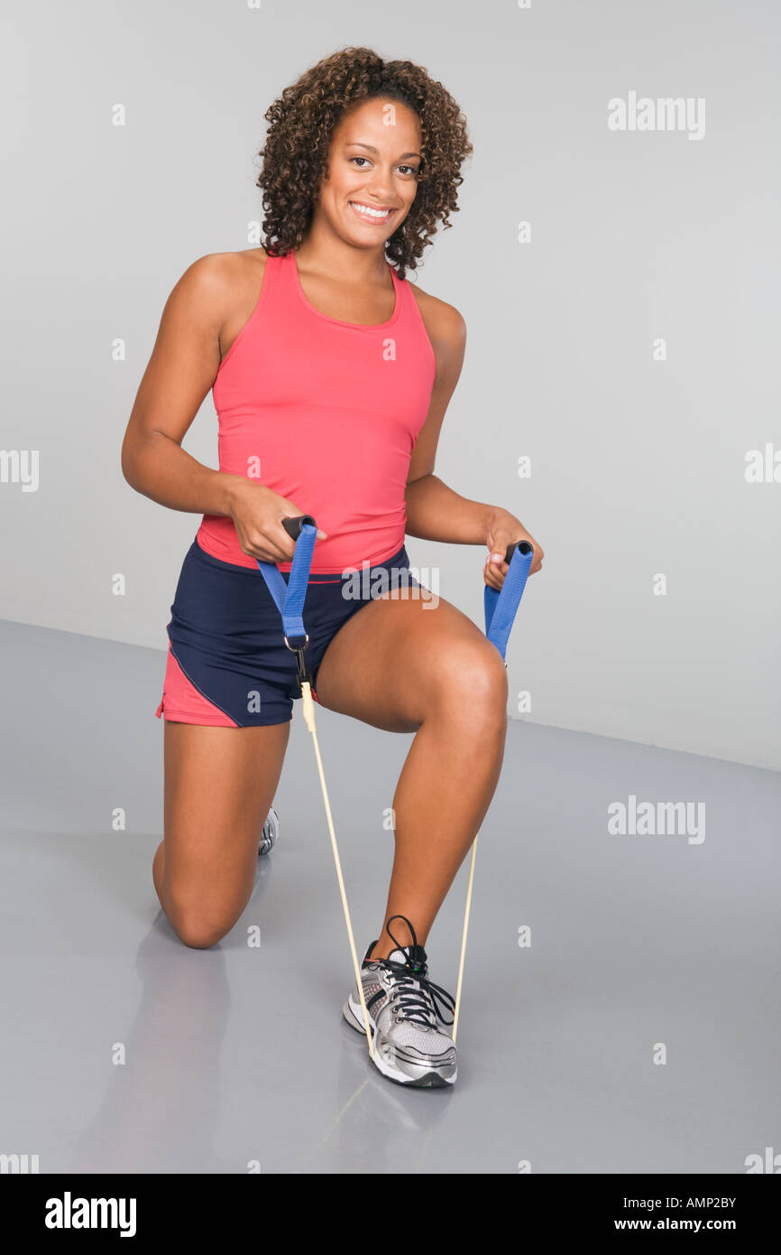 African woman exercising with elastic band Stock Photo