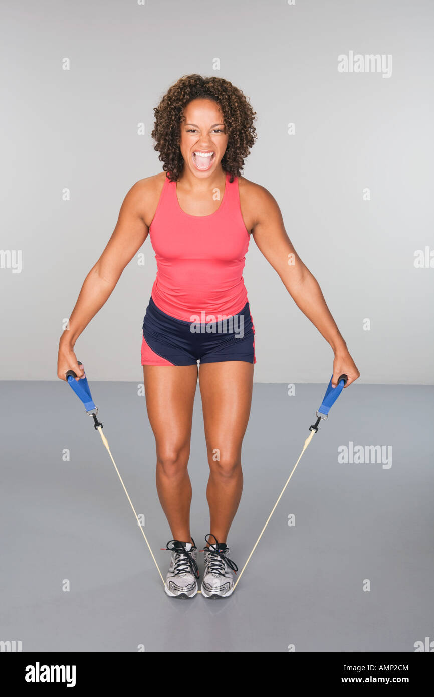 African woman exercising with elastic band Stock Photo