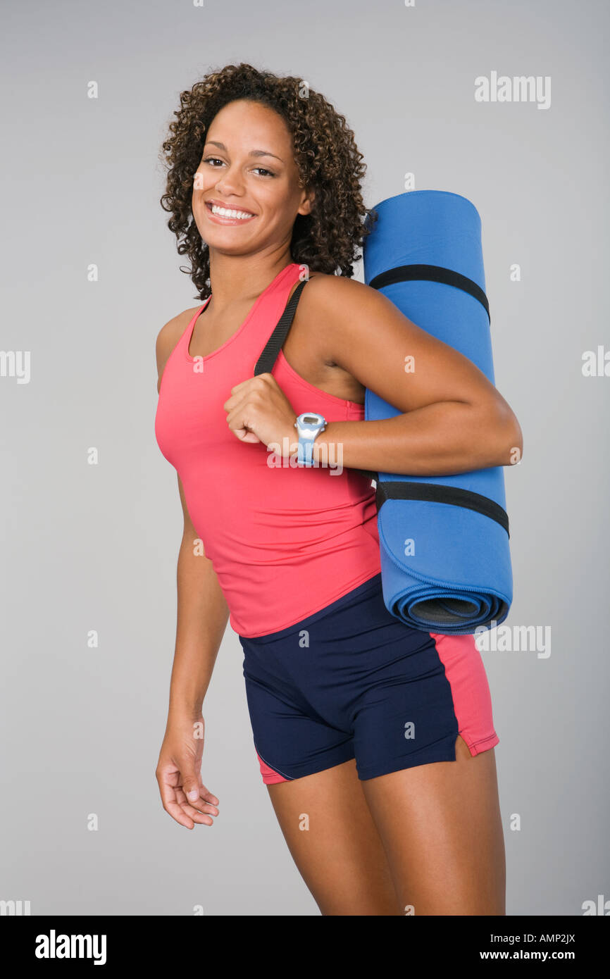 African woman carrying yoga mat Stock Photo Alamy